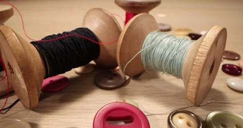 Super macro shot Spools, Needles and Threads on a wooden table. Stock Footage 168249106