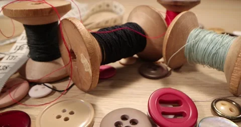 Super macro shot Spools, Needles and Threads on a wooden table. Stock Footage 168249262