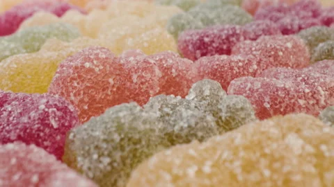 Super macro slider view of jelly gummy bears texture background.Colorful candies Stock Footage 243493236
