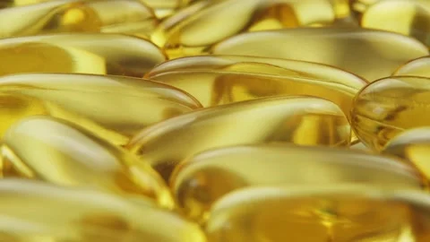 Super macro view omega 3 gold fish oil capsules, rotation background Stockbeeldmateriaal 155139384