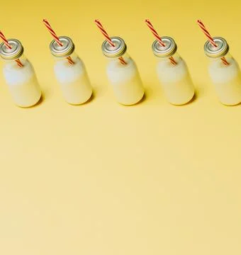 Super minimalist mockup of a milkshake pattern over a pastel yellow backgro.. Stock Photos