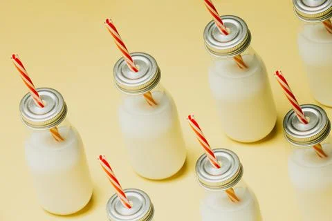 Super minimalist mockup of a milkshake pattern over a pastel yellow backgro.. Stock Photos