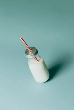 Super minimalist mockup of a milkshake pattern over a pastel blue backgroun.. Stock Photos