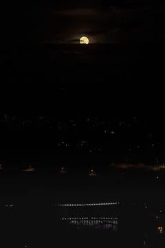 Super moon in deep dark night with blue illuminated Bridge over Aare in Switz 스톡 사진