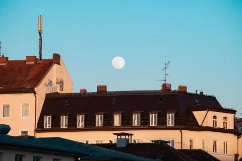 Super Moon over Rooftop on a hot sunny summer evening. Stock Photos