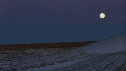 Super Moon over top of a snowy field. Stock Footage 102317451