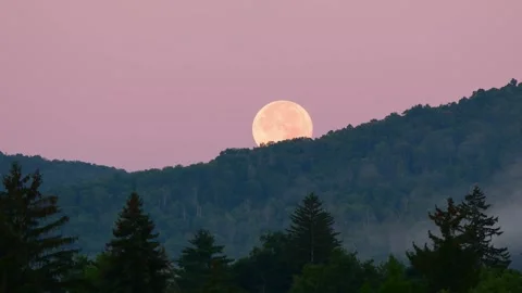 Super moon setting behind the mountain Stock Footage 255664503