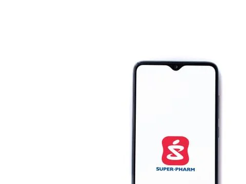 Super Pharm app launch screen with logo on the display of a black mobile smar Stock Photos