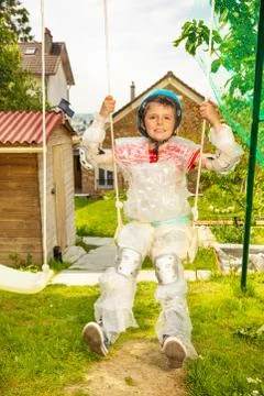 Super safe child in bubble wrap swing on swings Stock Photos