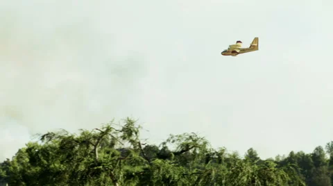 Super Scooper plane drops water on fire Stock-Footage 54642044