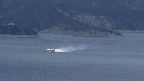 Super scooper slow motion distant scooping and lift off Stock Footage 79861729