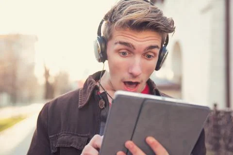 Super shocked man using tablet Stock Photos