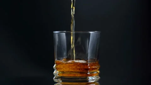 Super Shot of Pouring Whiskey into empty Glass Stock Footage 153530053