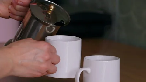 Super side view of coffee movement pouring into cup from geyser coffee machine. 스톡 동영상 129339849