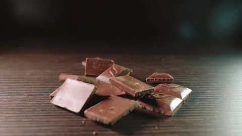 Super slow falling milk chocolate pieces. Stock Footage 165991778
