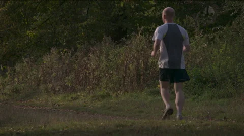 Super Slow Mo: Autumn evening Jogger HD Stock Footage 42942698