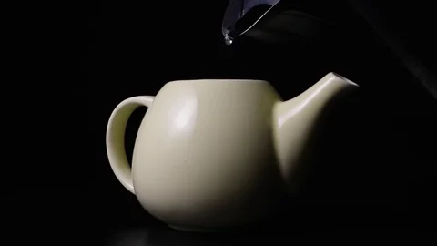 Super slow mo pouring boiling water into the teapot Stock Footage 72862552