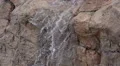 super slow mo water cascades over cliff day time loop HD動画