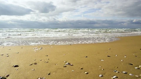 Super Slow Mo Wave rolls to the sandy beach Stock Footage 82658704