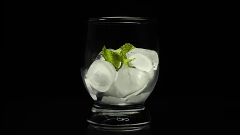 Super slow mo whiskey poured into ice Stock Footage 72894216