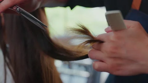 Super slow motion 100 frame rate Asian professional barber uses scissors to c Stock Footage 153821833