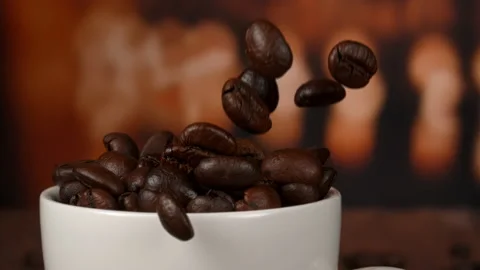 Super slow motion in 4k. Roasted coffee beans falls down in cup at 1000fps. Stock Footage 167473229
