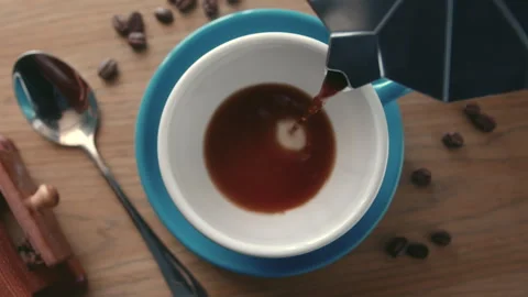 Super slow motion from above coffee pour into a cup from a geyser coffee maker Stock Footage 246761130