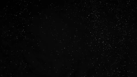 Super slow motion of artificial snow falling on black background Stock Footage 221683690