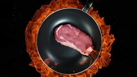 Super slow motion of beef steak in wok pan and fire blast on black background Stock Footage 145554854