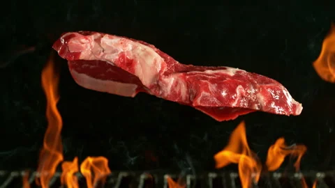 Super slow motion of beef steak falling on grill with fire on black background Stock Footage 270713696