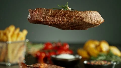 Super slow motion of beef steaks falling down. Stock Footage 237316674