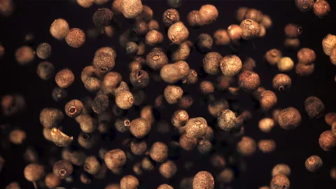 Super slow motion of black pepper peas soar upwards. On a black background Vidéo 153454728