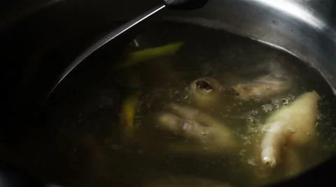 Super slow motion of boiling Thai soup in a pot, stirring Soup spoon Stock Footage 65869824