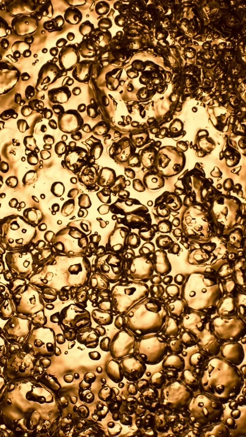 Super Slow Motion of Bubbling Golden Liquid in Detail. Stock Footage 289003063