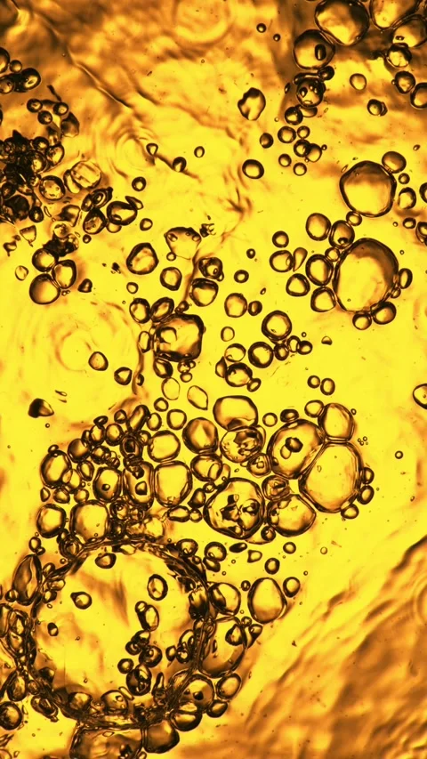 Super Slow Motion of Bubbling Golden Liquid in Detail. Stock Footage 289007058