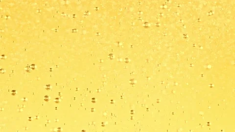Super slow motion of bubbling water on golden background. Stock Footage 237153564