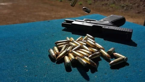 Super slow motion Bullets droping/Falling Glock background Stock Footage 124360130