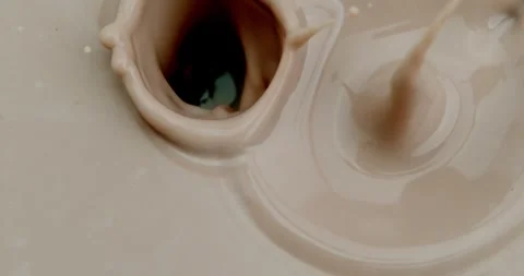 Super Slow Motion of a bunch of chocolate chips falling into chocolate Milk Video stock 259995286