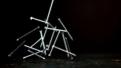Super slow motion a bunch of nails fall on the table Stock Footage 271277432