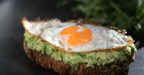 Super slow motion, Captivating Visual Of Multigrain Toast With Creamy Avocado An Stock Footage 331721186