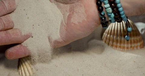 Super Slow Motion Caucasian Hand Sifting Sand With Shell Bracelets  Stock Footage 335109232