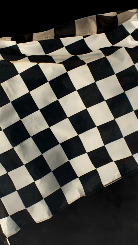 Super Slow Motion of Checkered Race Flag Waving Continuously in the Wind Stock Footage 295030308