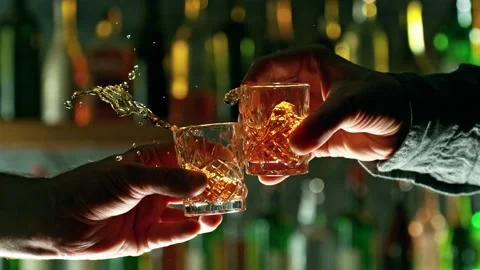 Super slow motion of cheering hard spirit drinks in bar. Stock Footage 233250499