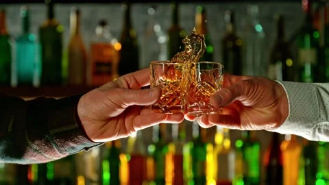 Super slow motion of cheering hard spirit drinks in bar. Stock Footage 233256383