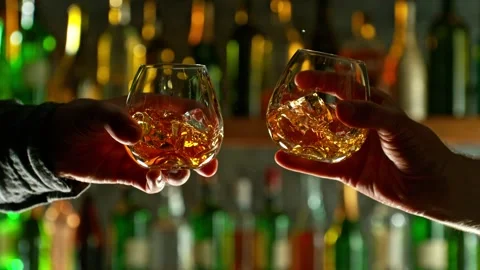 Super slow motion of cheering whiskey drinks in bar. Stock Footage 233250373