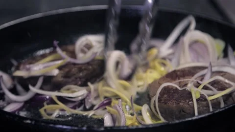 Super slow motion: chef cooking in a pan fried meat pieces in onion. Making meal Stock Footage 141109883