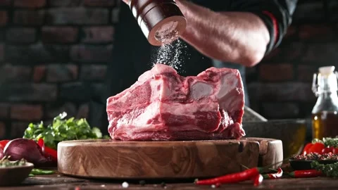 Super slow motion of chef grinding salt on beef steak. Stock Footage 169671221