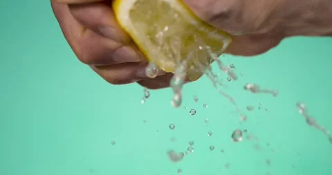 Super Slow Motion Chef Hand Squeezing Lemon Juice Droplets  Stock Footage 333485255