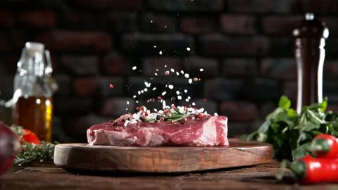 Super slow motion of chef throwing spices on beef steak. Stock Footage 169671550
