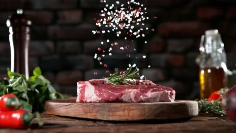 Super slow motion of chef throwing spices on beef steak. Stock Footage 169671662